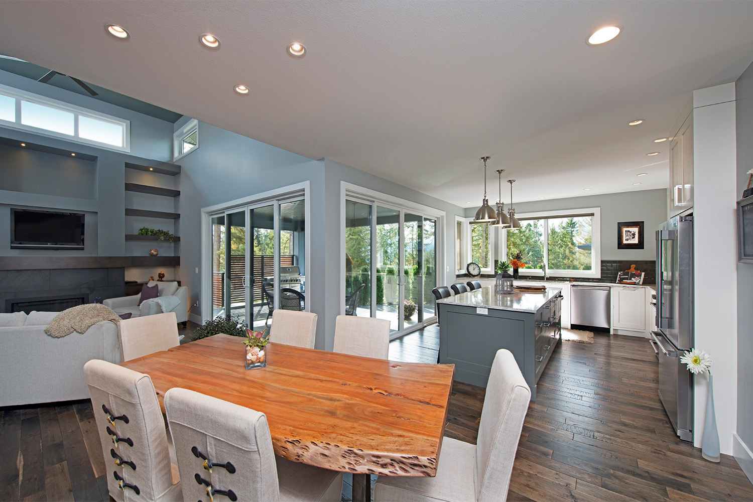 kitchen with granite countertop island, rustic dining room, natural light from sliding glass doors
