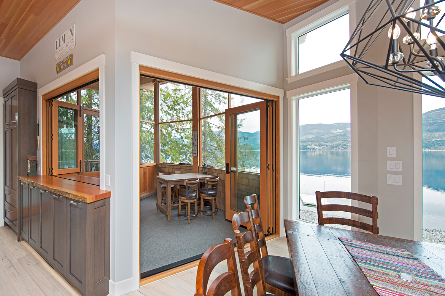 sun room with side table, bar and view of shuswap lake