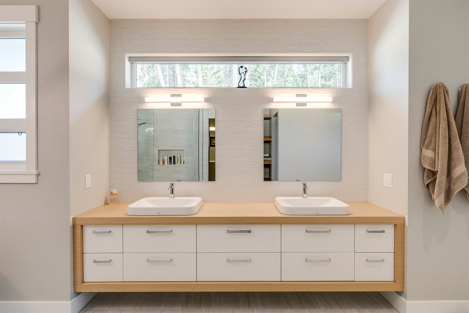 modern bathroom with lengthy short window above double vanity