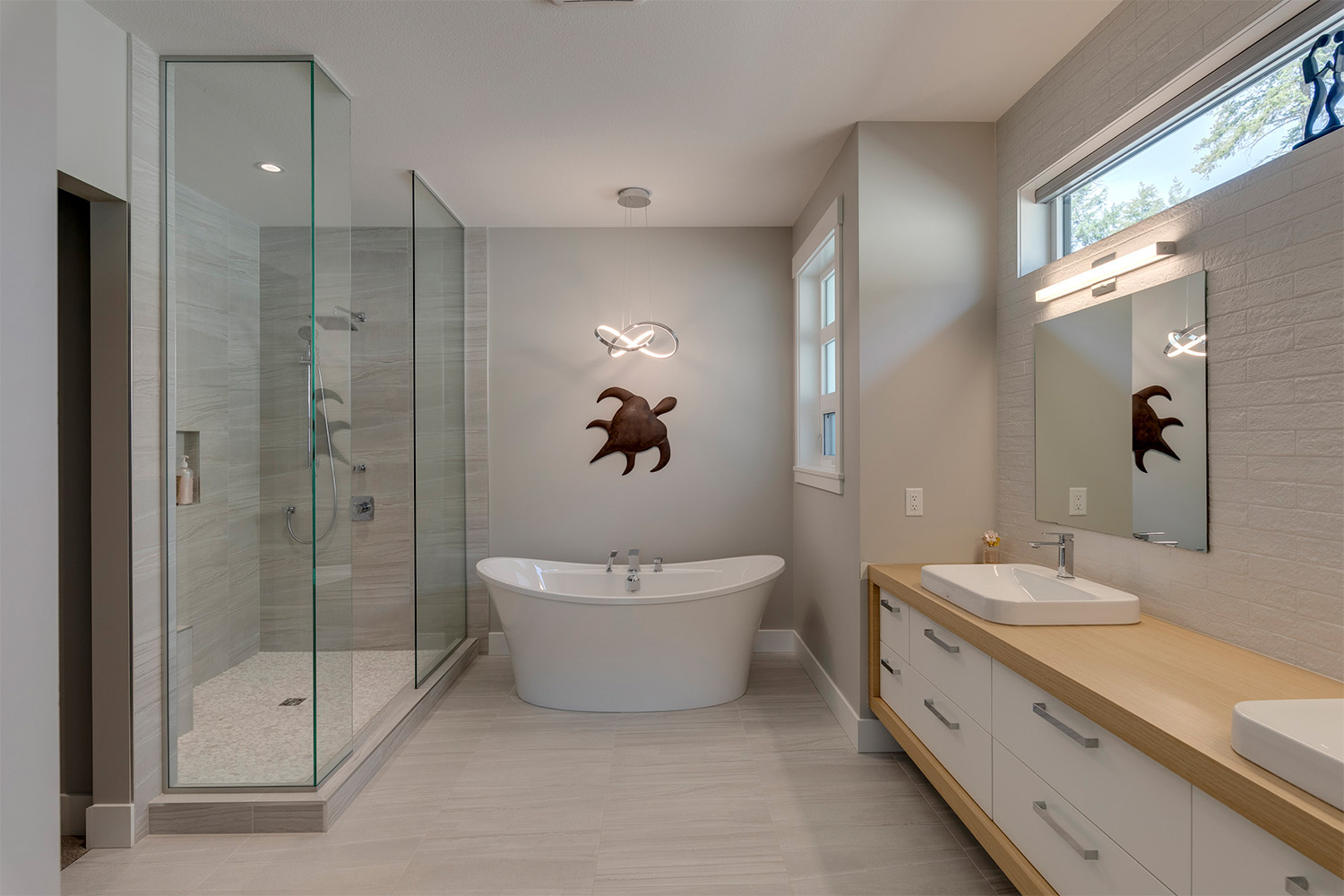 spacious shower panel with white/grey tile. bronze turtle decor