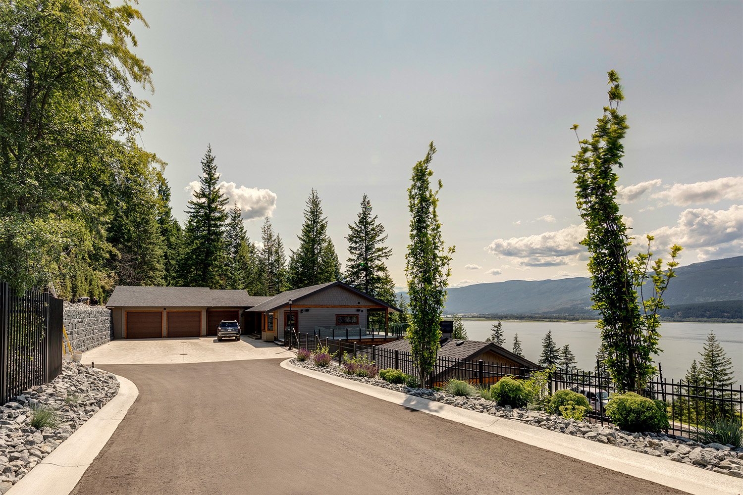 private driveway to upper garage of custom built home on hillside with dream view of nature